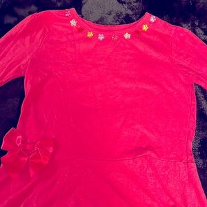 Garanimals used girls long sleeve pink shirt with bow on the bottom.